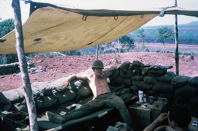 John 'Doc' Mountain relaxing under a canvas awning, 1970