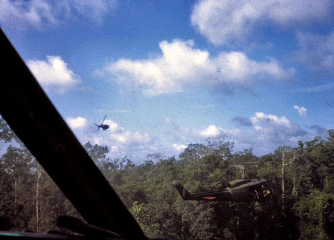 A helicopter gunship pulls away after making a firing pass