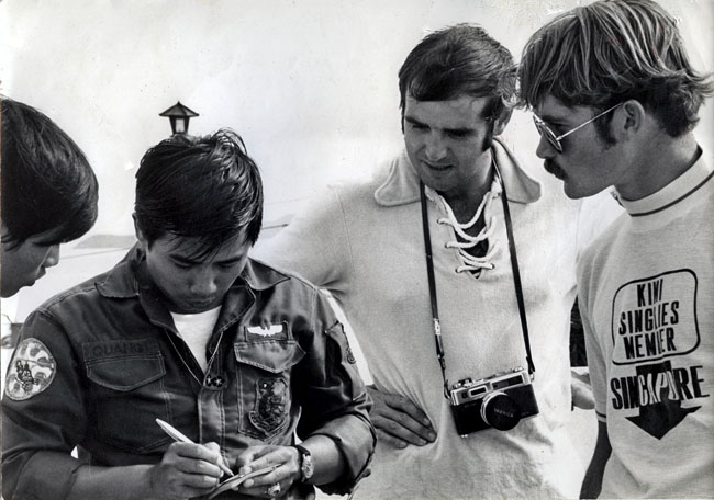 Peter Crotty [middle] in conversation with South Vietnamese pilot, circa 1973