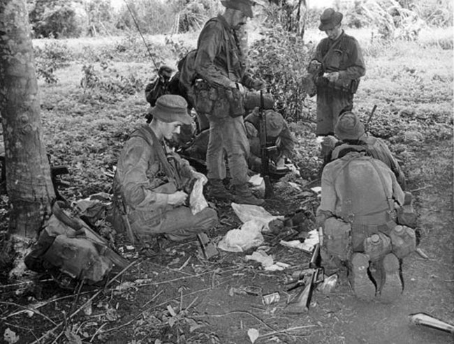 Soldiers from Victor 4 Company examine enemy documents, 1969