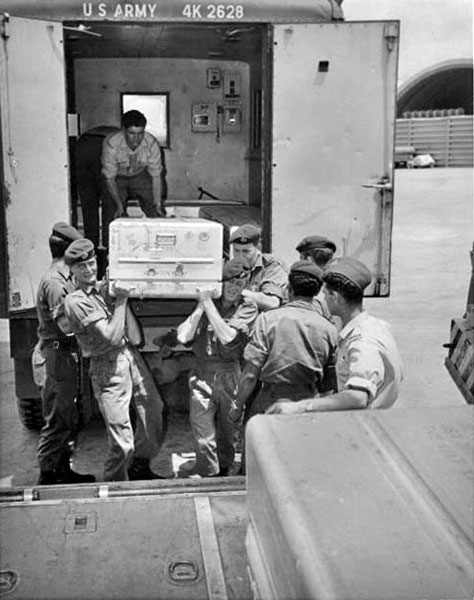 Loading coffins for return to New Zealand