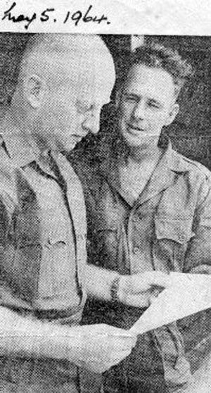 Sergeant's P. Quinn and J. W. Carter discuss troop newspaper, 5 May 1964