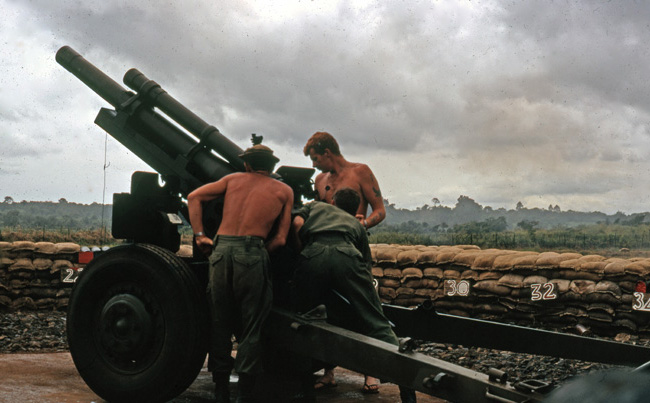 Preparing to fire M101A1 Howitzer, circa 1966-1967