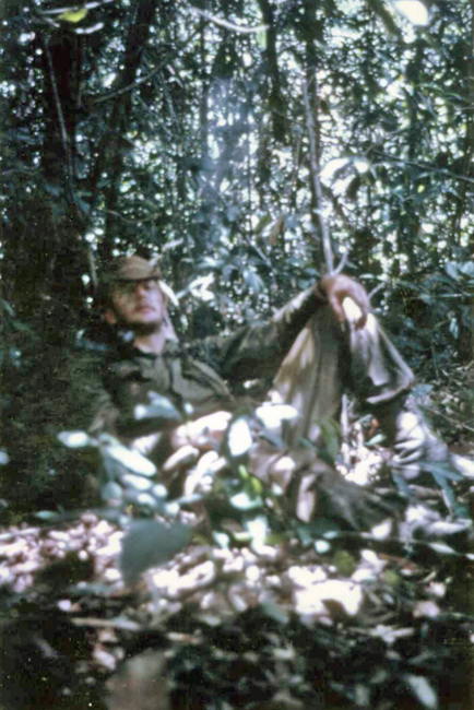 Jim Ellis resting during a patrol, 1970