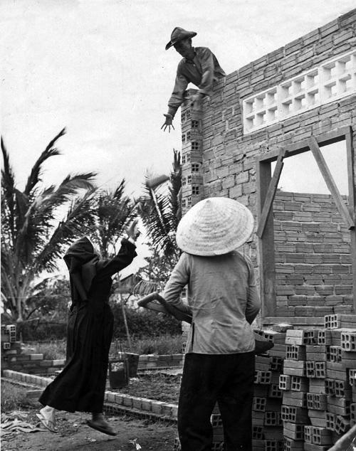 A nun lends a hand during the construction of a new classroom at Binh Loi orphanage, circa 1969 A nun lends a hand during the construction of a new classroom at Binh Loi orphanage, circa 1969