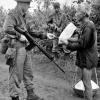 Brian Wilson checks a Vietnamese civilian's identification card, 1967