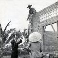 A nun lends a hand during the construction of a new classroom at Binh Loi orphanage, circa 1969