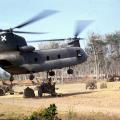 Chinook helicopter moving Howitzer artillery, circa 1968